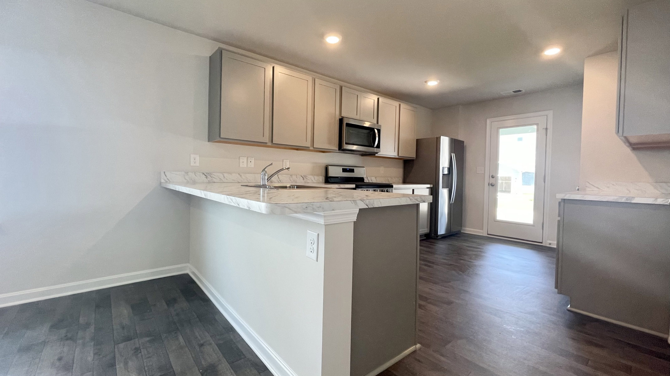 The well-appointed kitchen features an abundance of cabinetry.