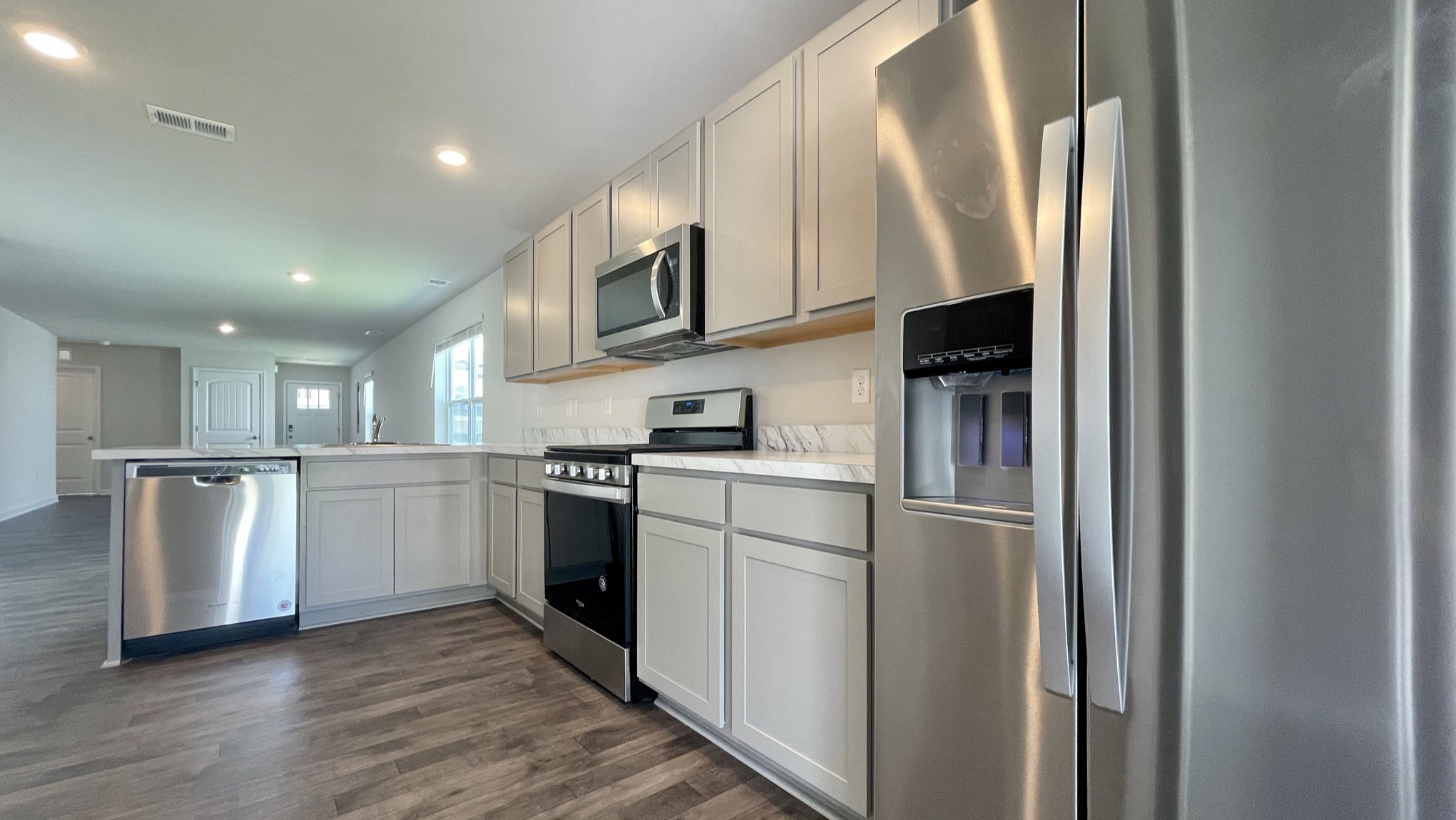 The well-appointed kitchen features stainless steel appliances.