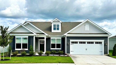 A Galveston one-story home with green siding.