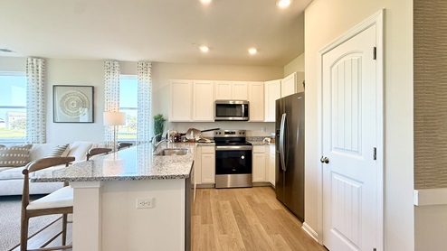 The home's functional eat-in kitchen features ample cabinet space.