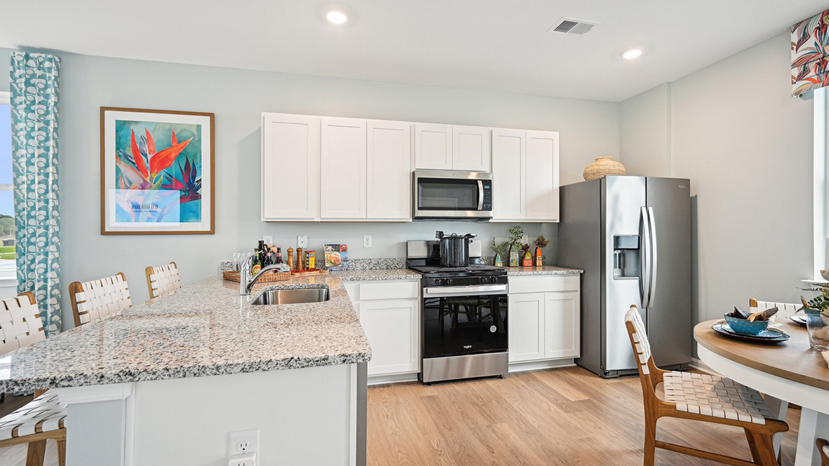 The kitchen includes stainless steel appliances.