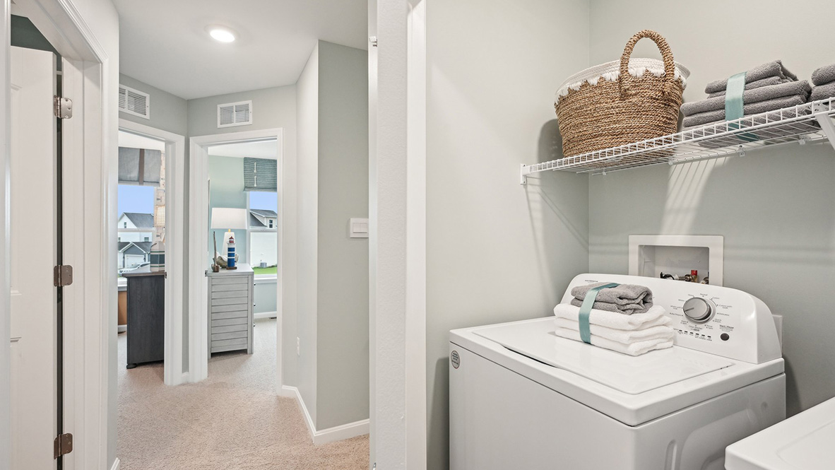 The laundry closet comes complete with a washer and dryer.