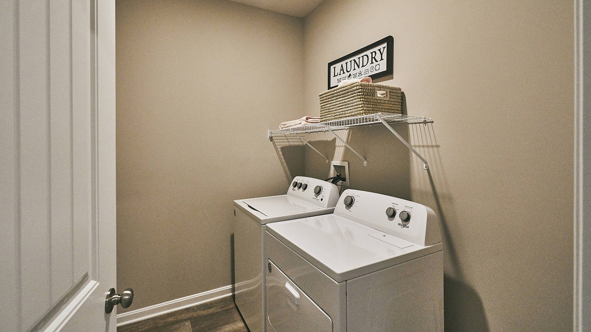 The laundry room is tucked behind the kitchen.