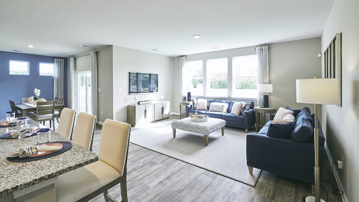 Featuring plank flooring, the kitchen is open to the living room.