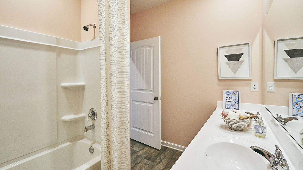A shared guest bathroom has a double-bowl vanity.