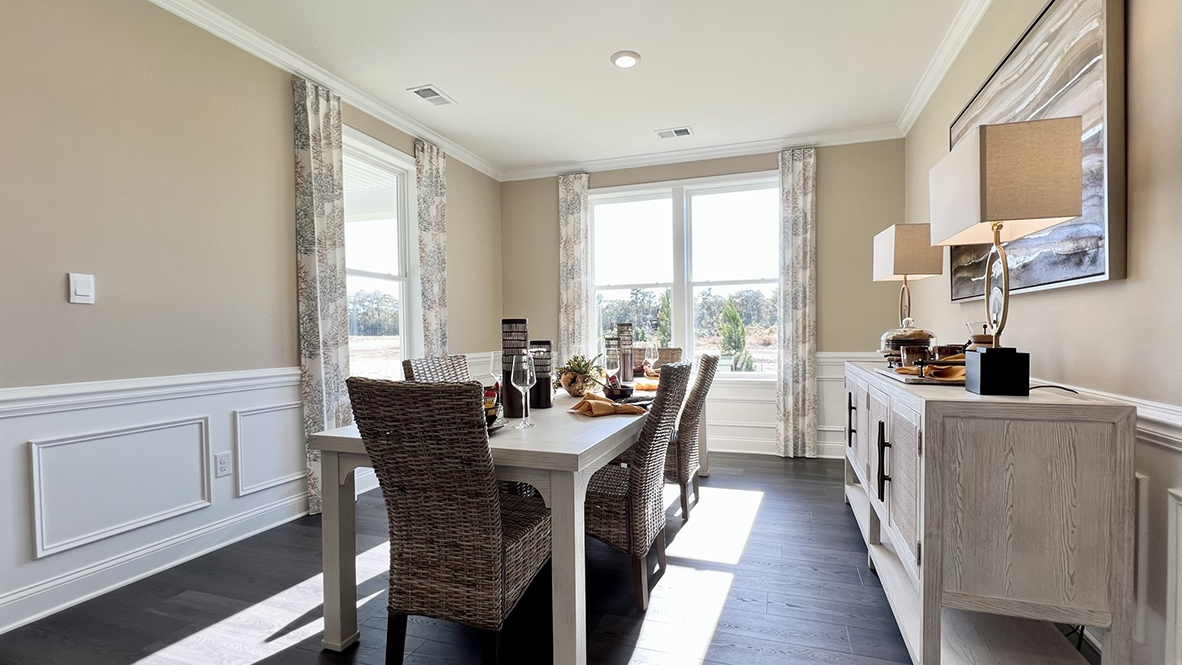 The dining room is surrounded by windows.