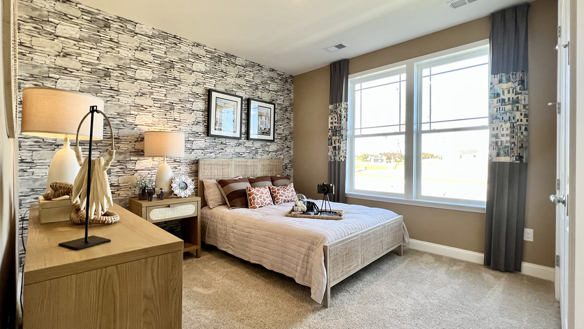 The first guest bedroom has large windows for lots of light.