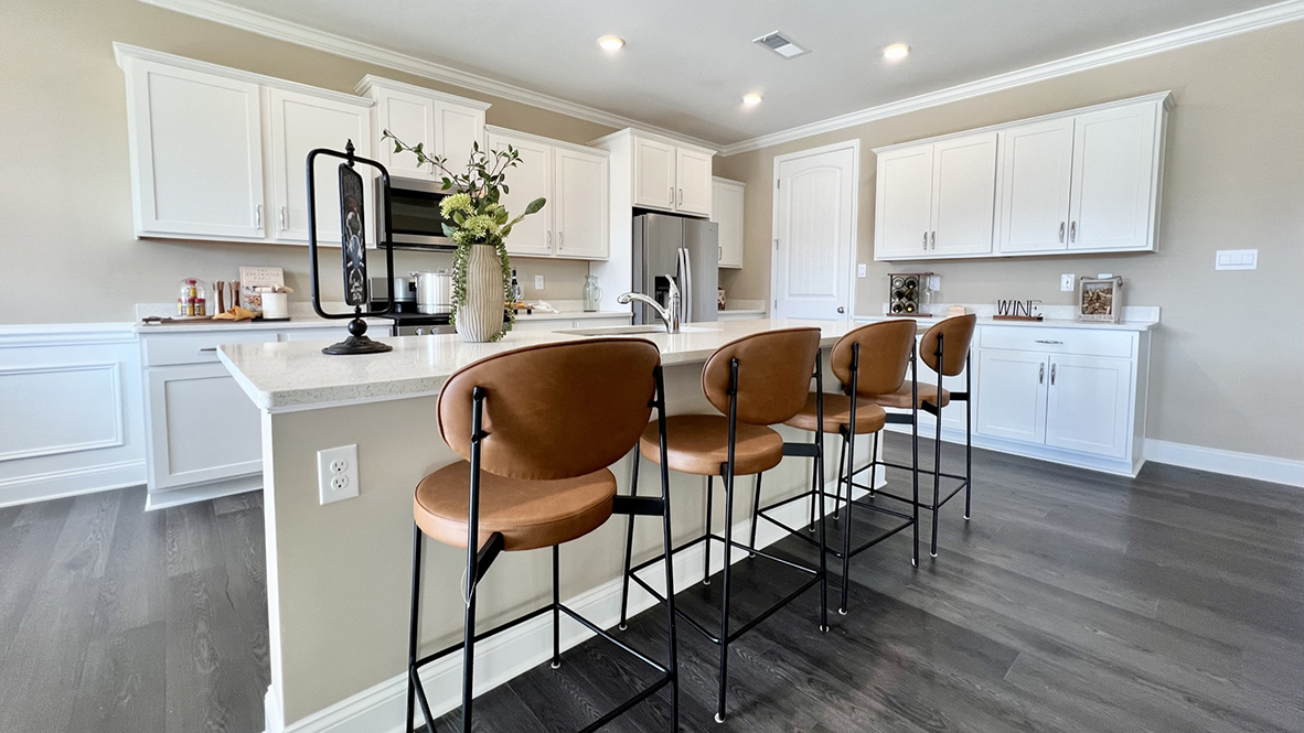 The gourmet kitchen with an expansive island showcases quartz countertops.