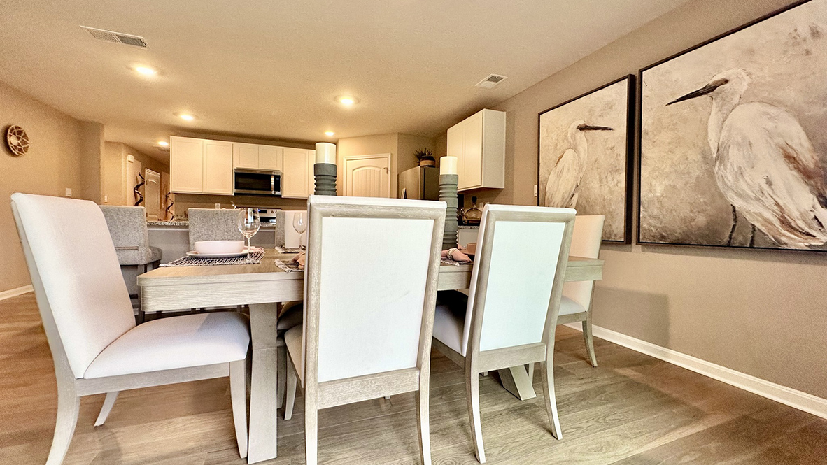 Laminate plank flooring continues through the dining area.