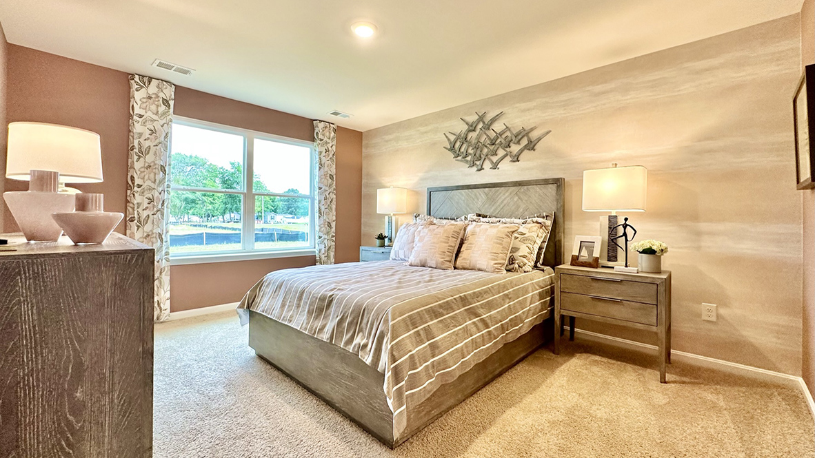 The primary bedroom has a large double window.