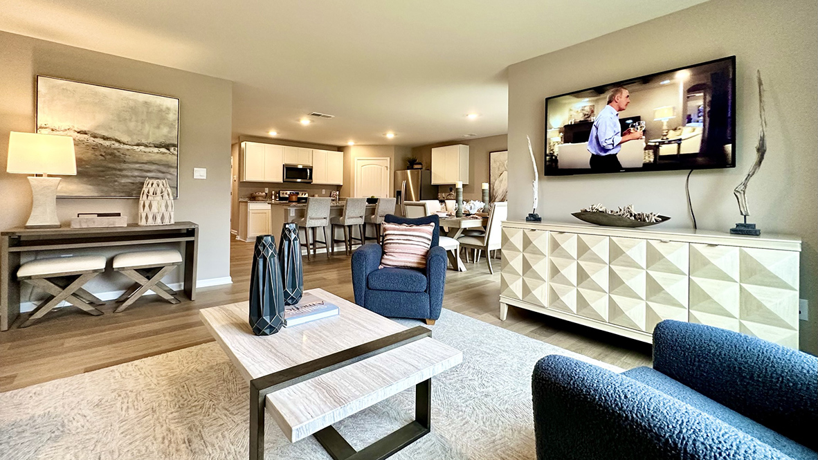 The open-concept floorplan connects the living, dining and kitchen