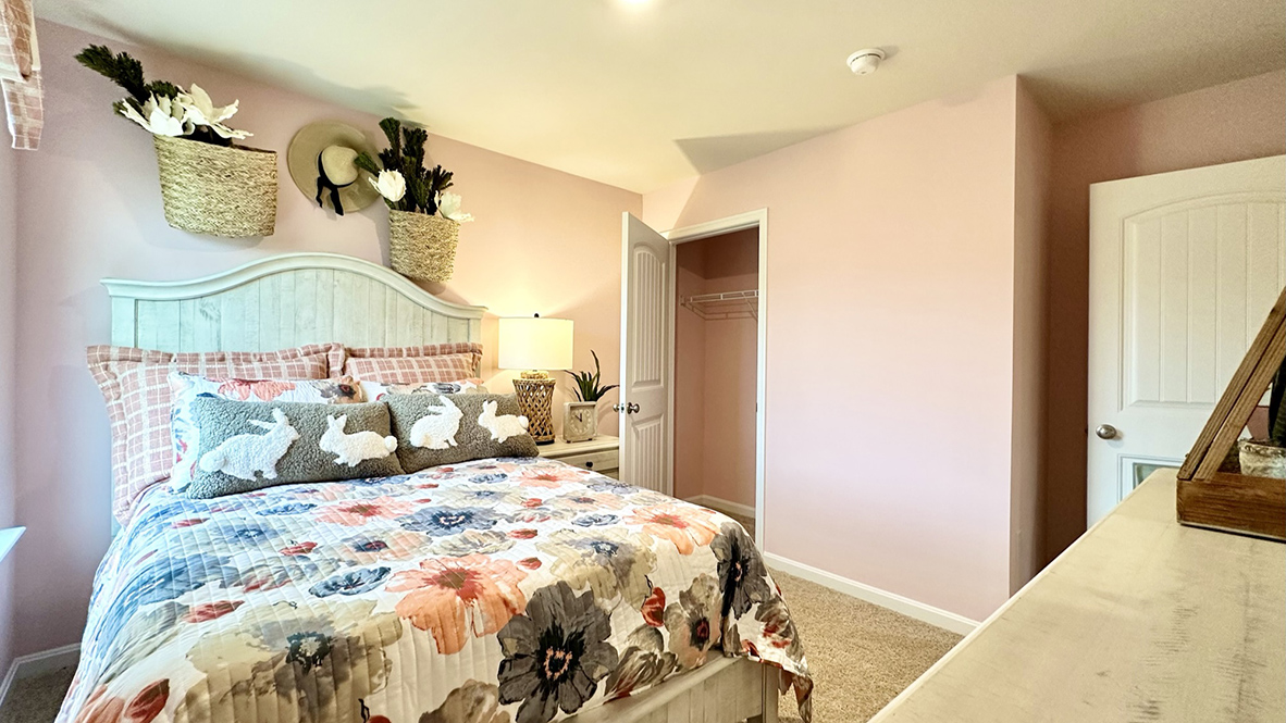 The guest bedroom has a corner closet.