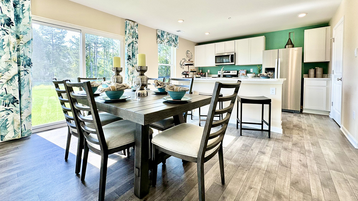 Dining area that overlooks sliding glass door to backyard.