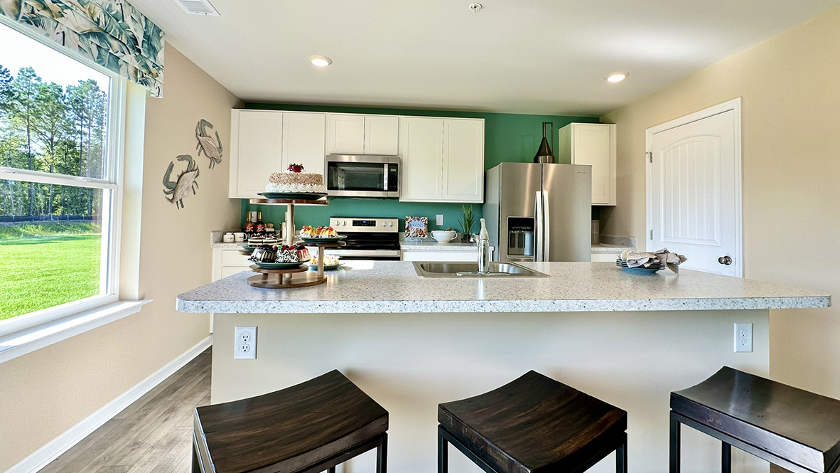 The spacious kitchen includes granite countertops.