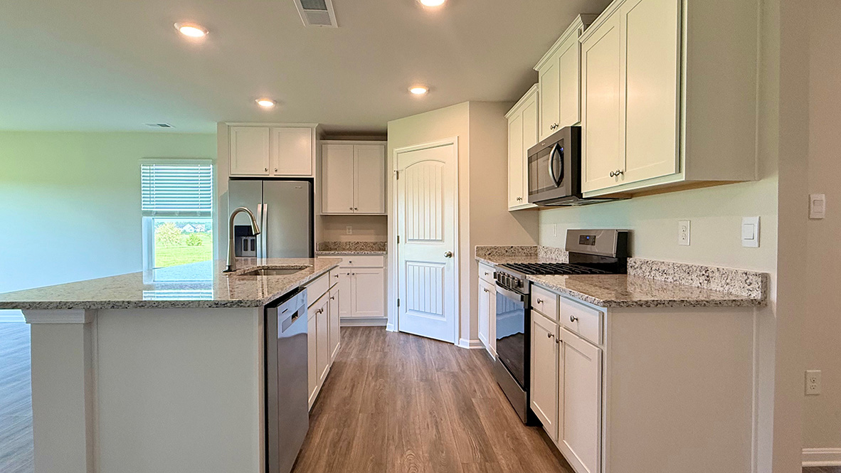 The home's well-designed kitchen features tasteful cabinetry.