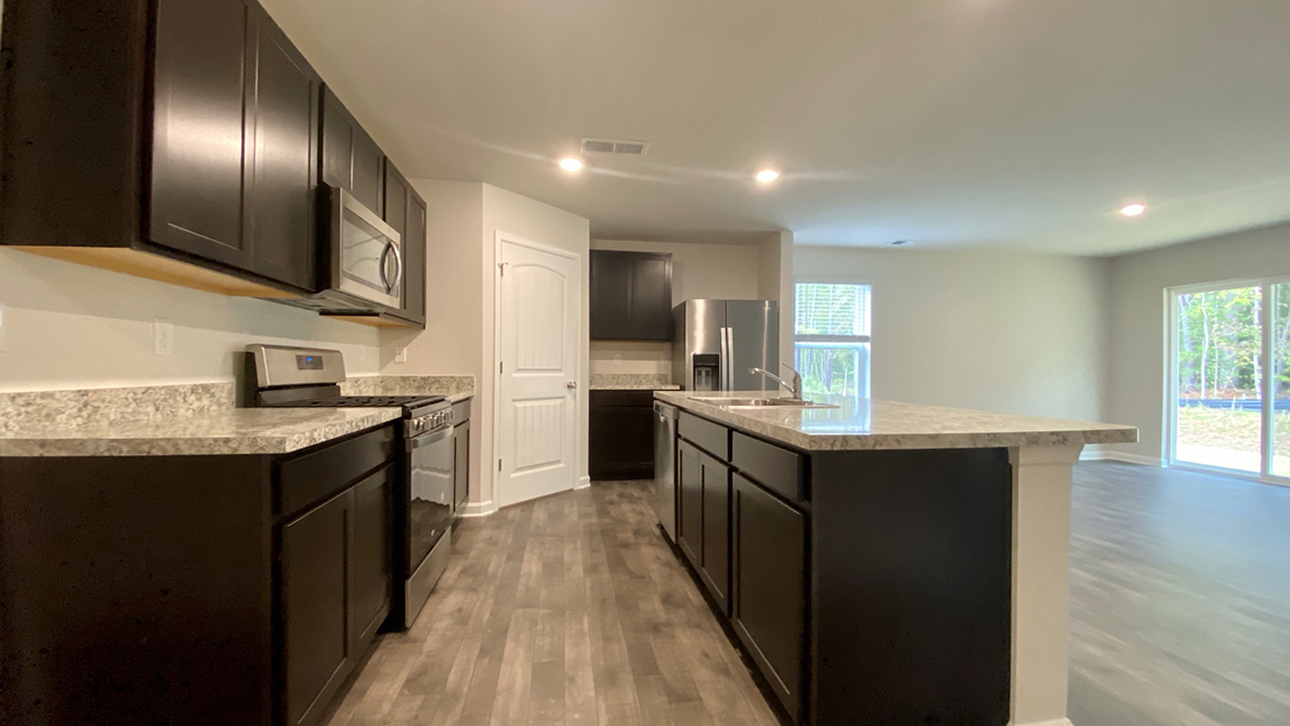 The home's well-designed kitchen features tasteful cabinetry.