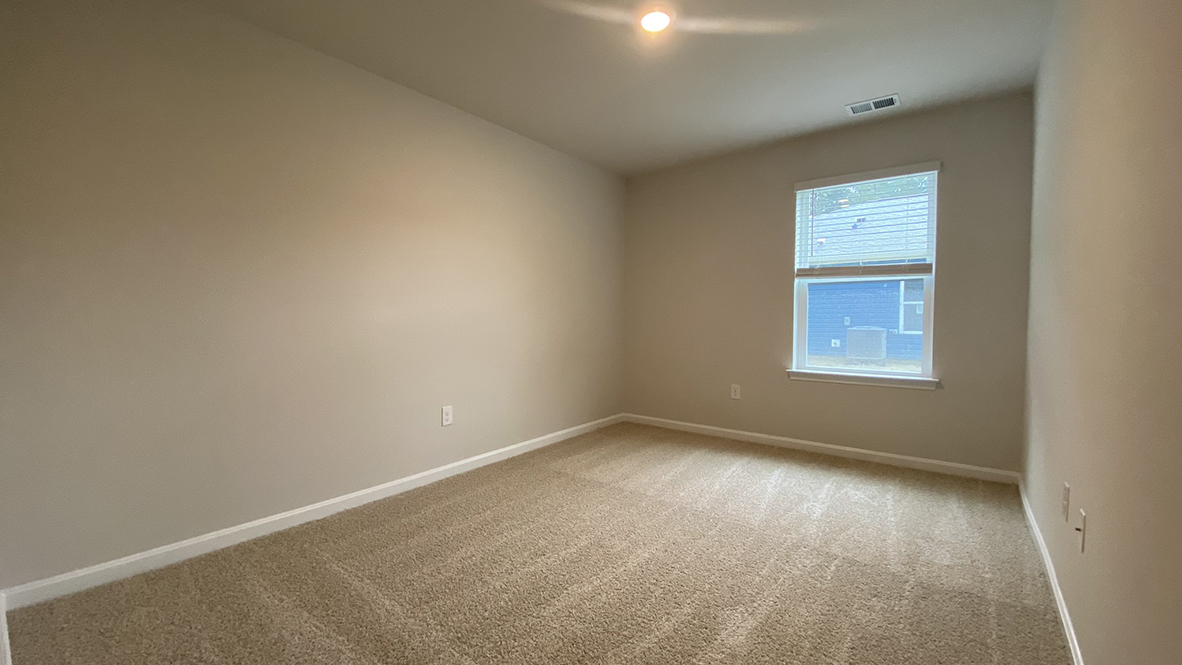 A spacious guest bedroom with a closet is in the front of the home.