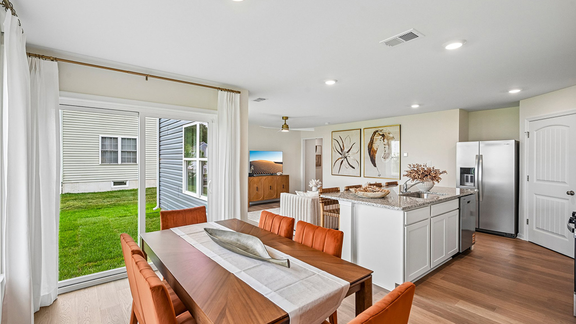 The eat-in kitchen that overlooks the casual dining area and a sliding glass door for easy access to the backyard.