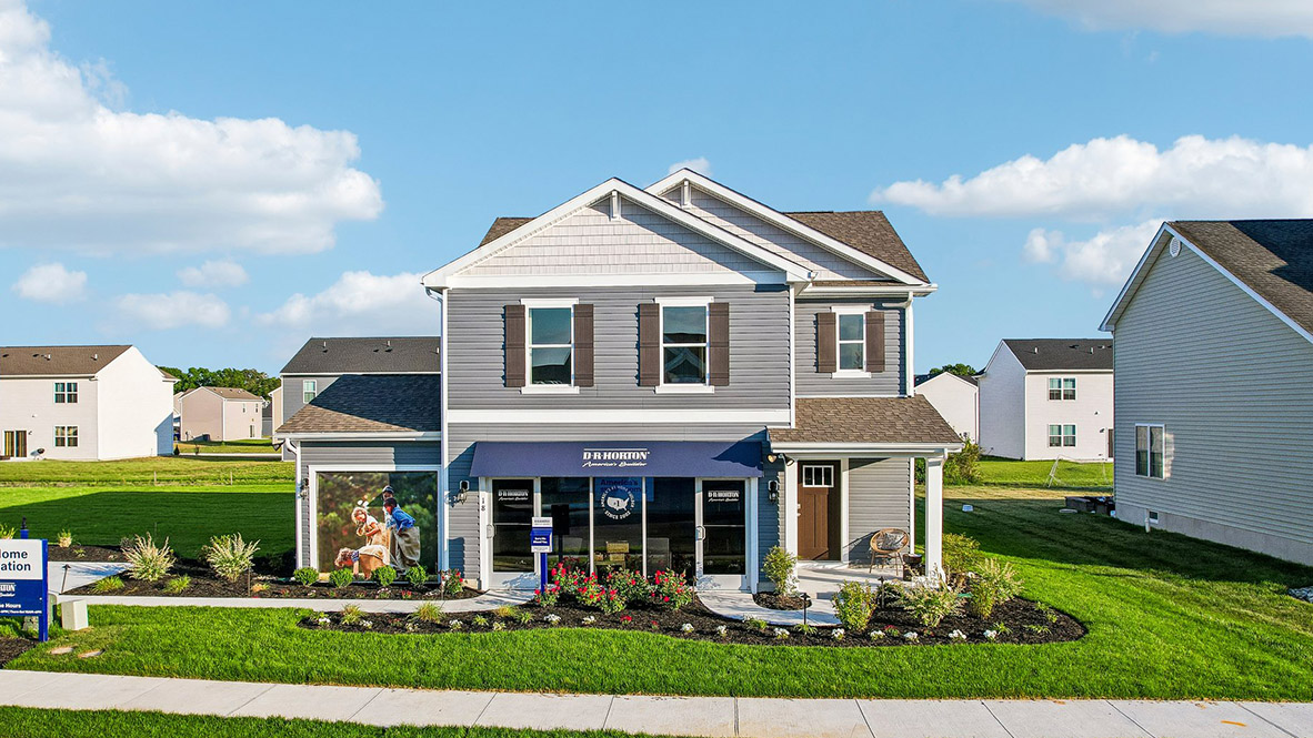 A two-story Cabral model home with blue siding and black shutters.