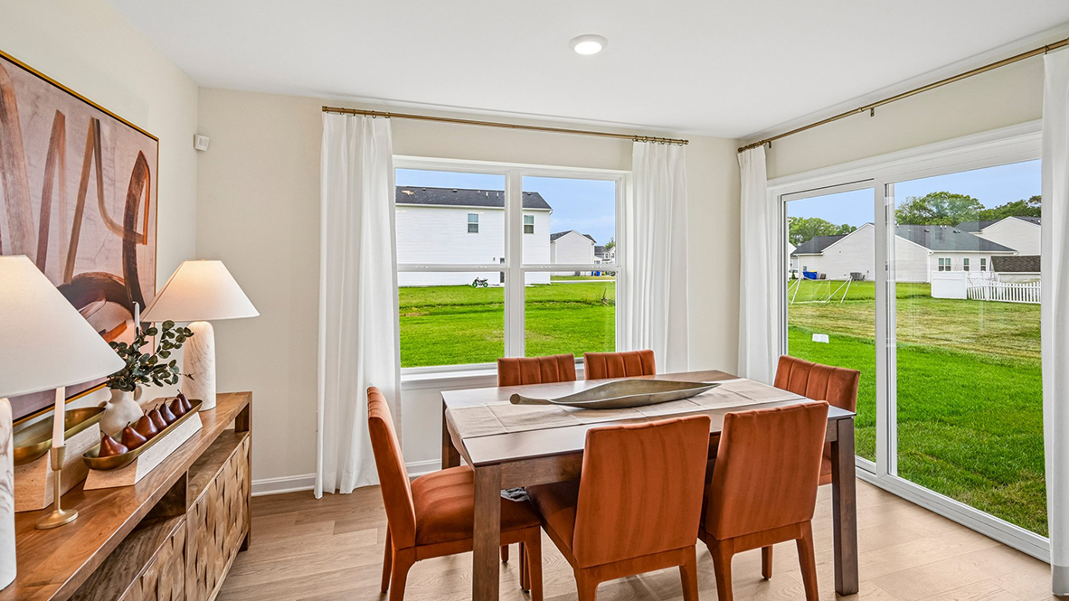 The eat-in kitchen that overlooks the casual dining area and a sliding glass door for easy access to the backyard.