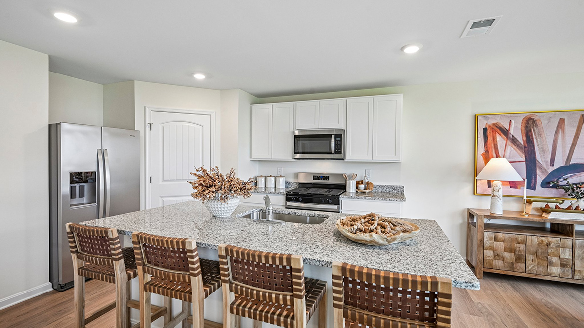The welcoming kitchen comes with an island with enough room for seating.