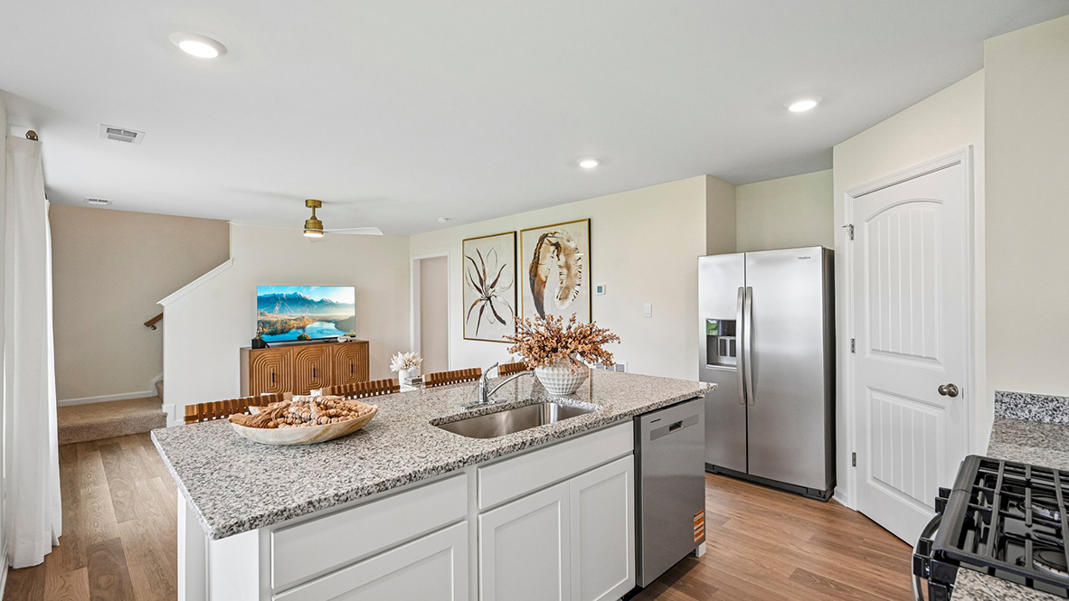 The welcoming kitchen comes with an impressive walk-in corner pantry.