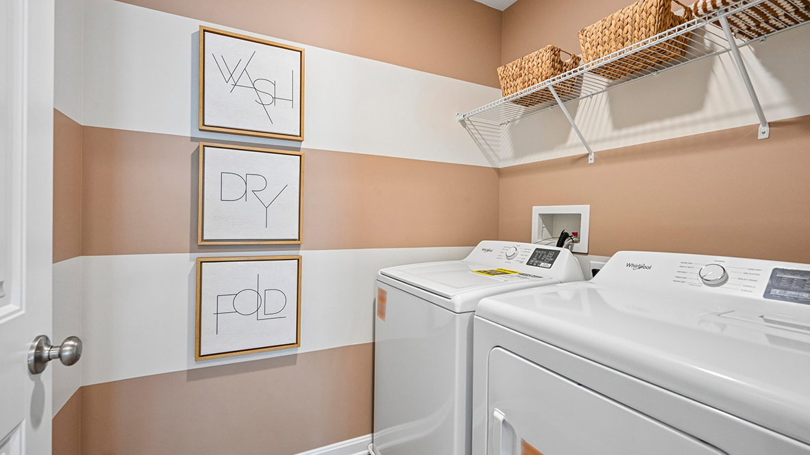 The laundry room is centrally located upstairs along with a hall linen closet.