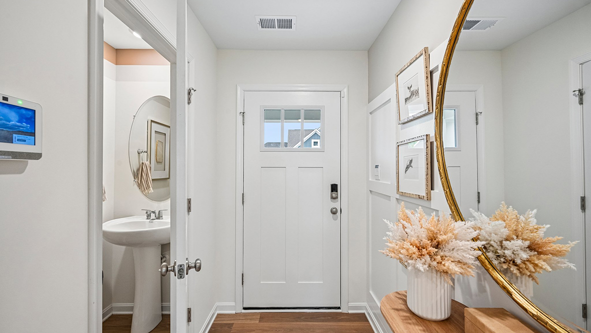 As you make your way from the front porch into the foyer you will find a convenient first-floor powder room.