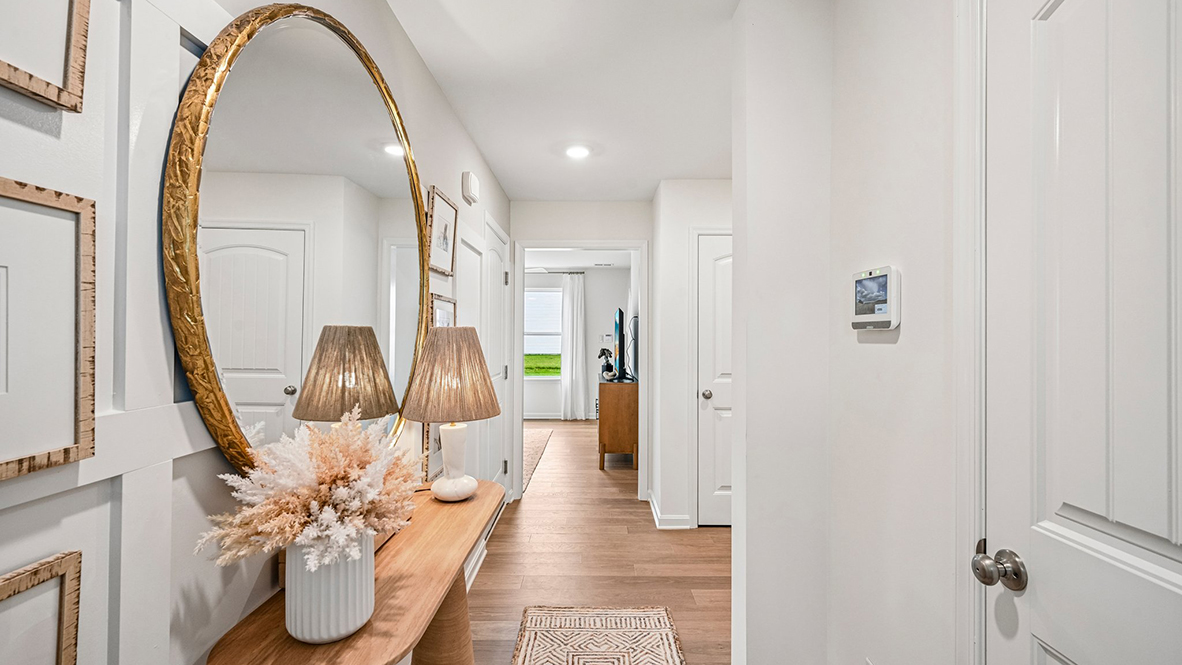 As you make your way from the front porch into the foyer you will find a convenient first-floor powder room and coat closet.