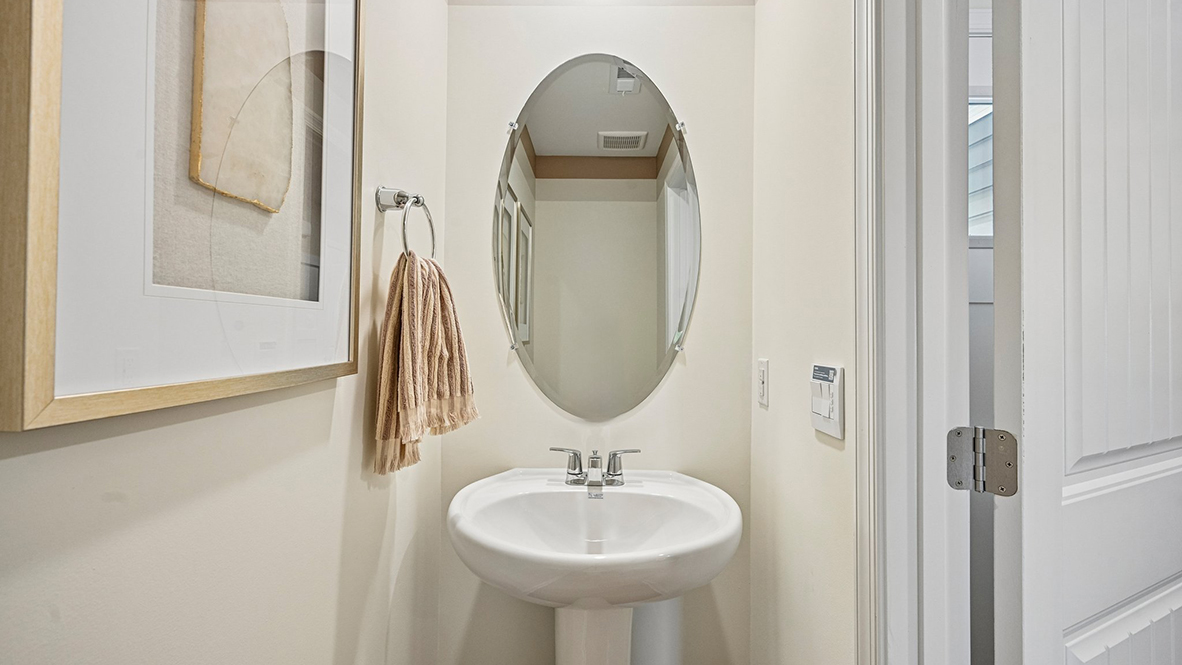 As you make your way from the front porch into the foyer you will find a convenient first-floor powder room.