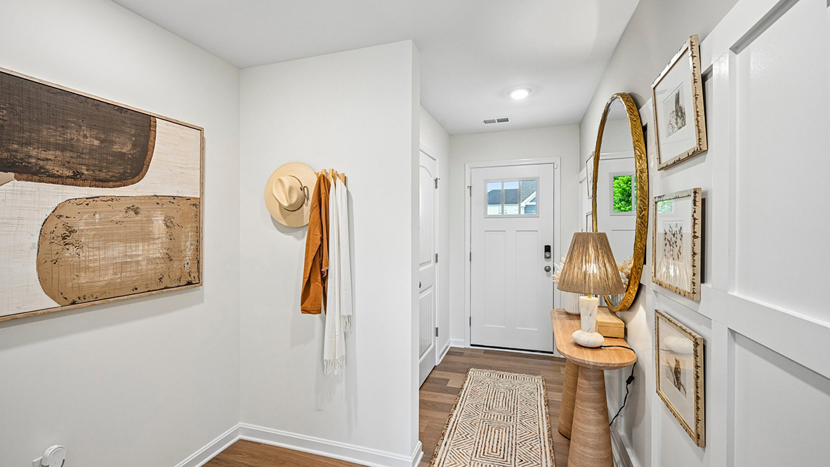 As you make your way from the front porch into the foyer you will find a convenient first-floor powder room and coat closet.