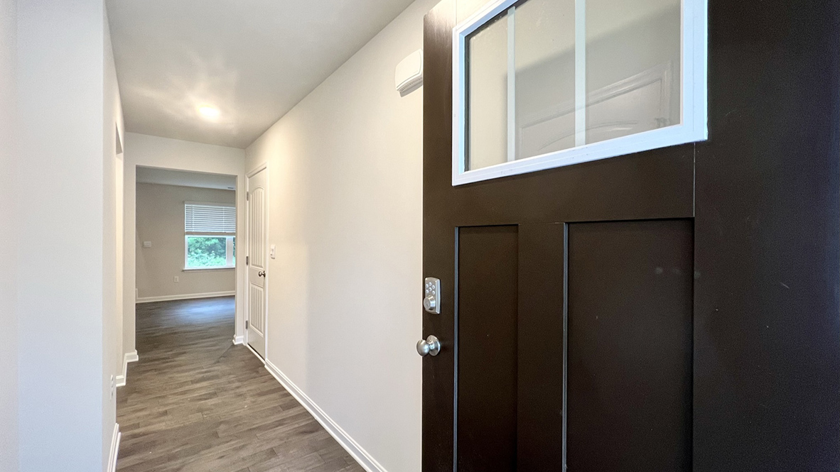 As you make your way from the front porch into the foyer you will find a convenient first-floor powder room and coat closet.