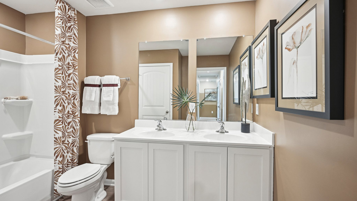 The second full bathroom has a double-bowl vanity and tub shower.
