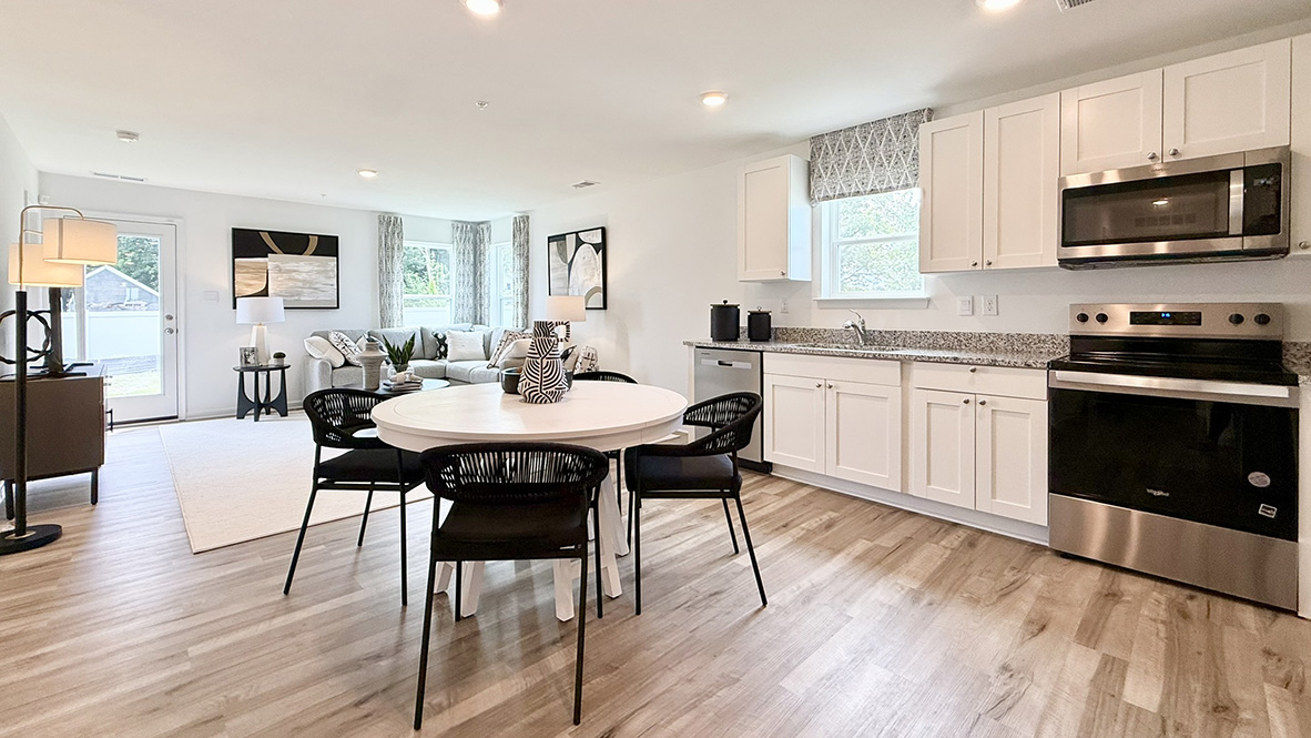 The open-concept kitchen boasts modern cabinetry.