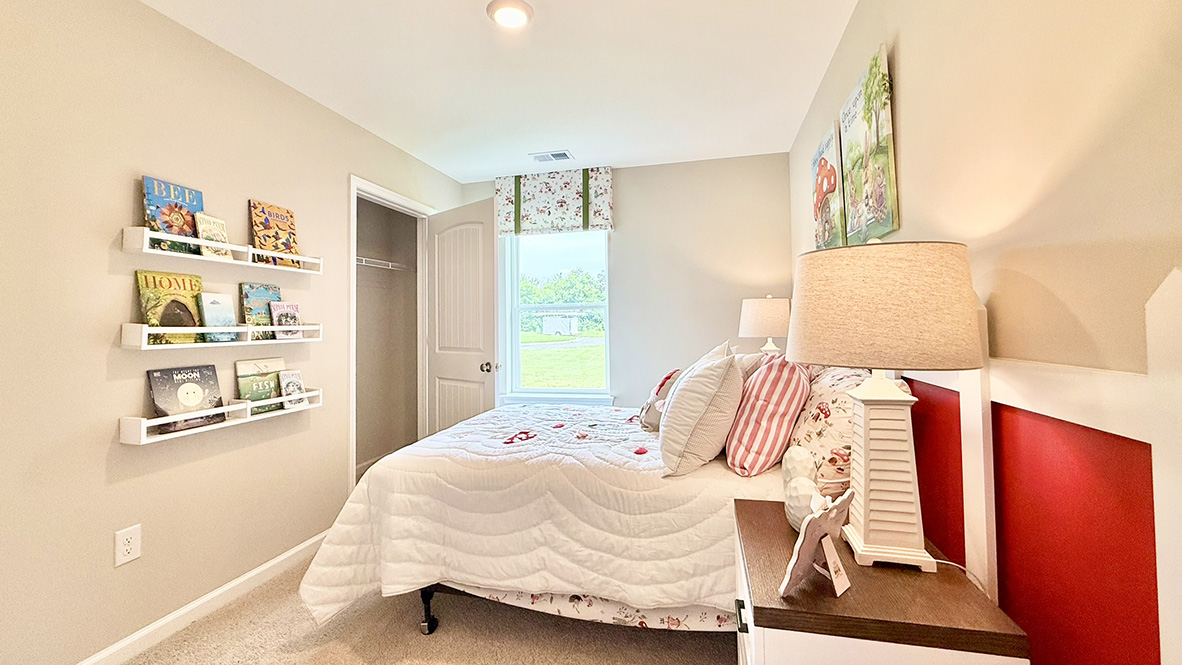 Just off the foyer, two spacious guest bedrooms and a shared full bathroom offer comfort and privacy for family or visitors.