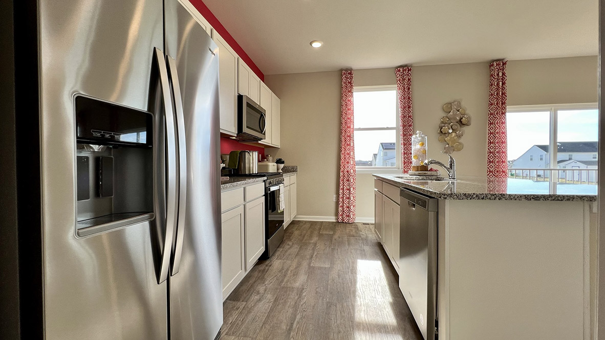 The well-designed kitchen features stainless steel appliances.