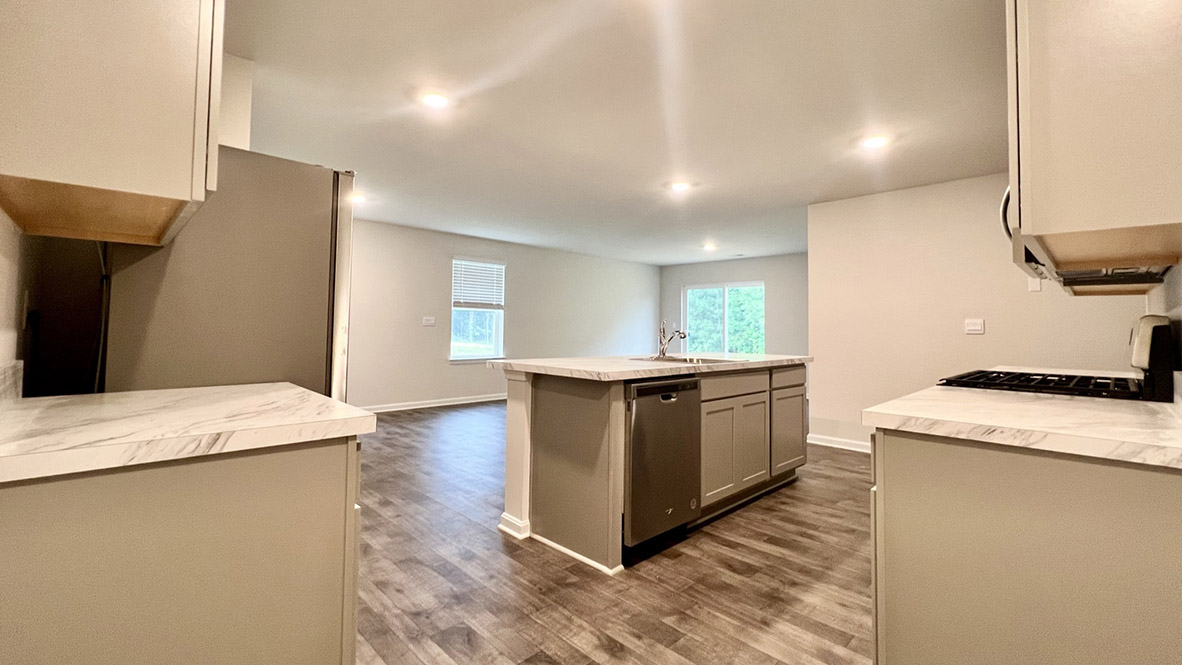 The large kitchen island has granite countertops.