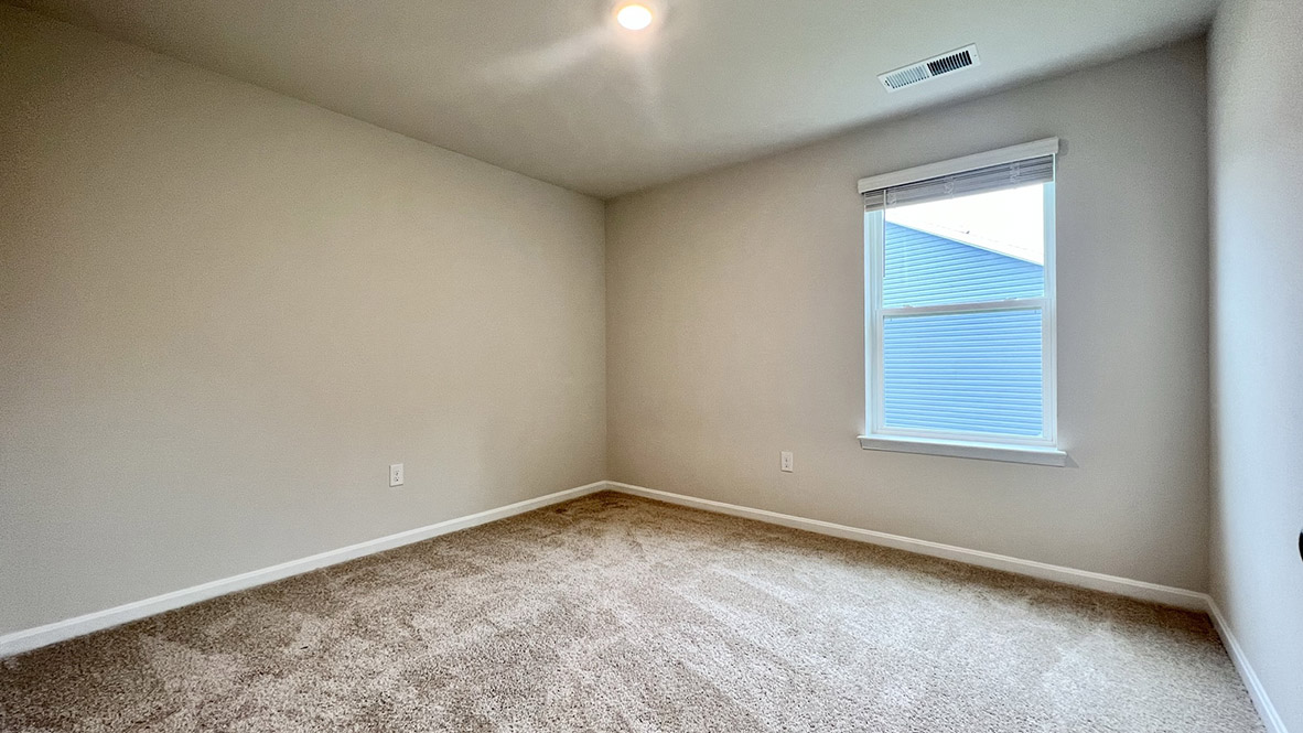A secondary bedroom with a window.