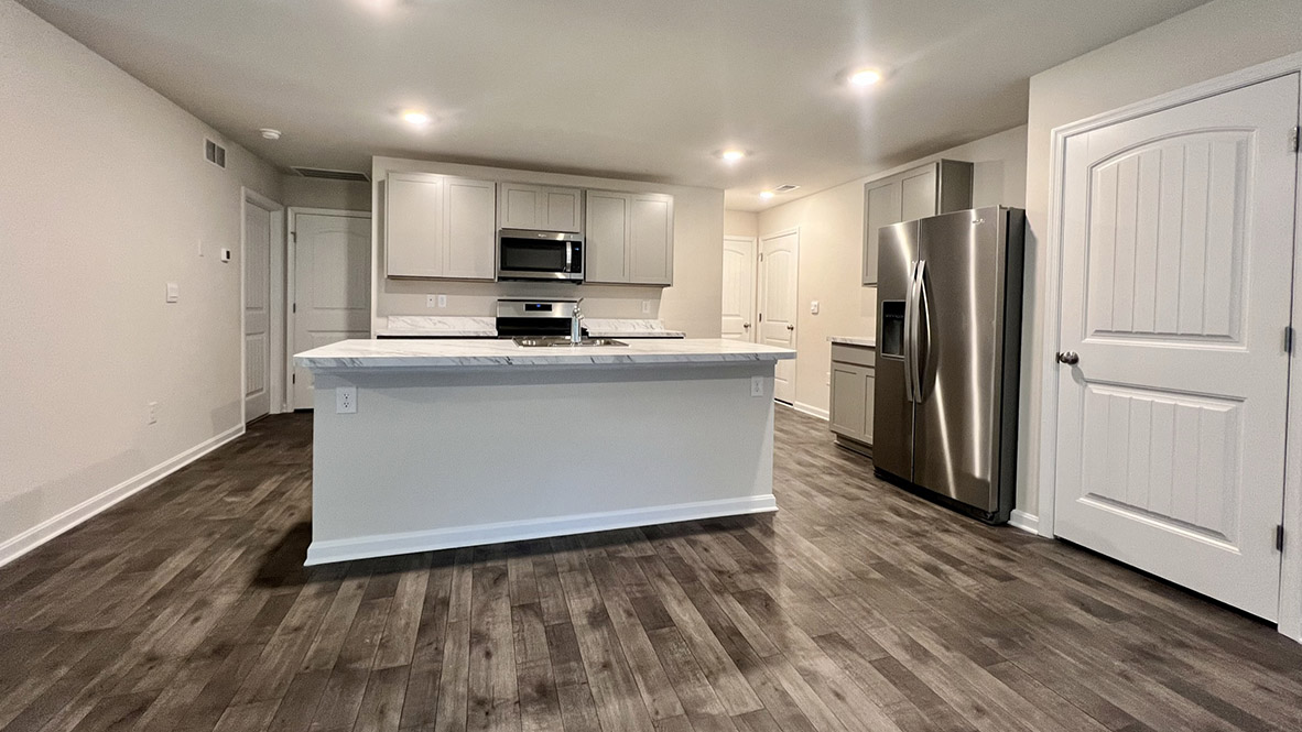The spacious kitchen showcases an abundance of cabinetry.