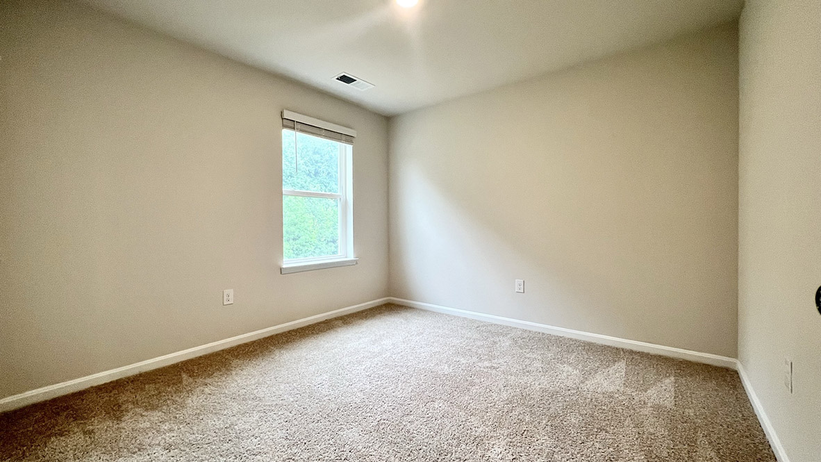 A secondary bedroom with a window.