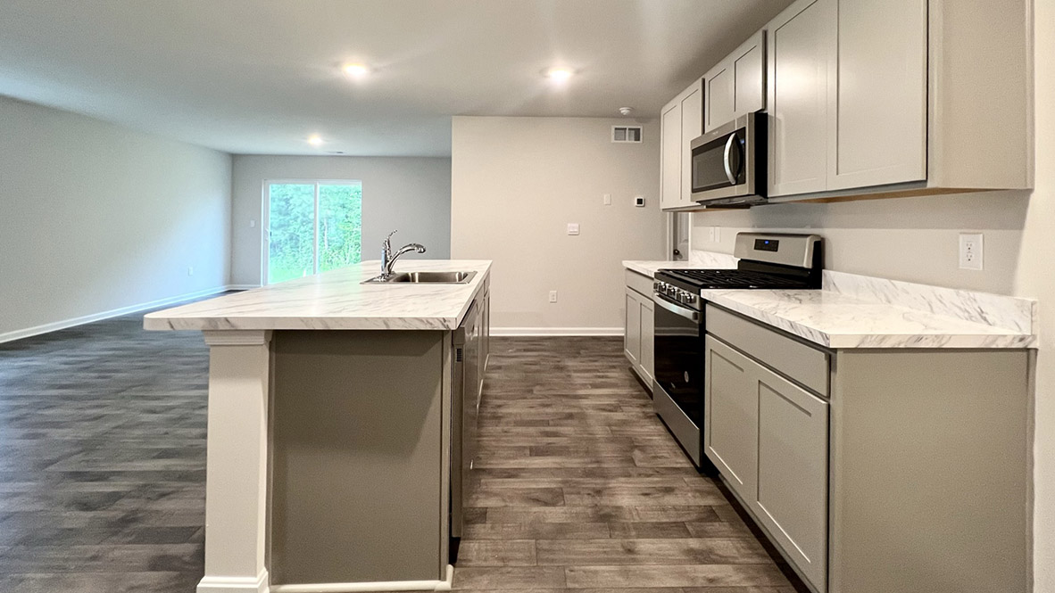 The kitchen has an eat-in dining space that flows perfectly into the sizeable living room.