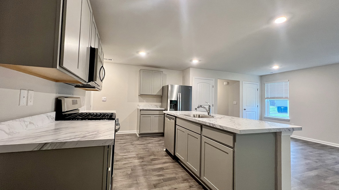The spacious kitchen showcases stainless steel appliances.