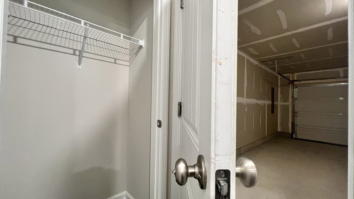 A coat closet is tucked away near the entrance of the garage.