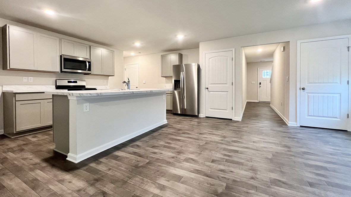 The open-concept floorplan comes to life as you take in the kitchen.