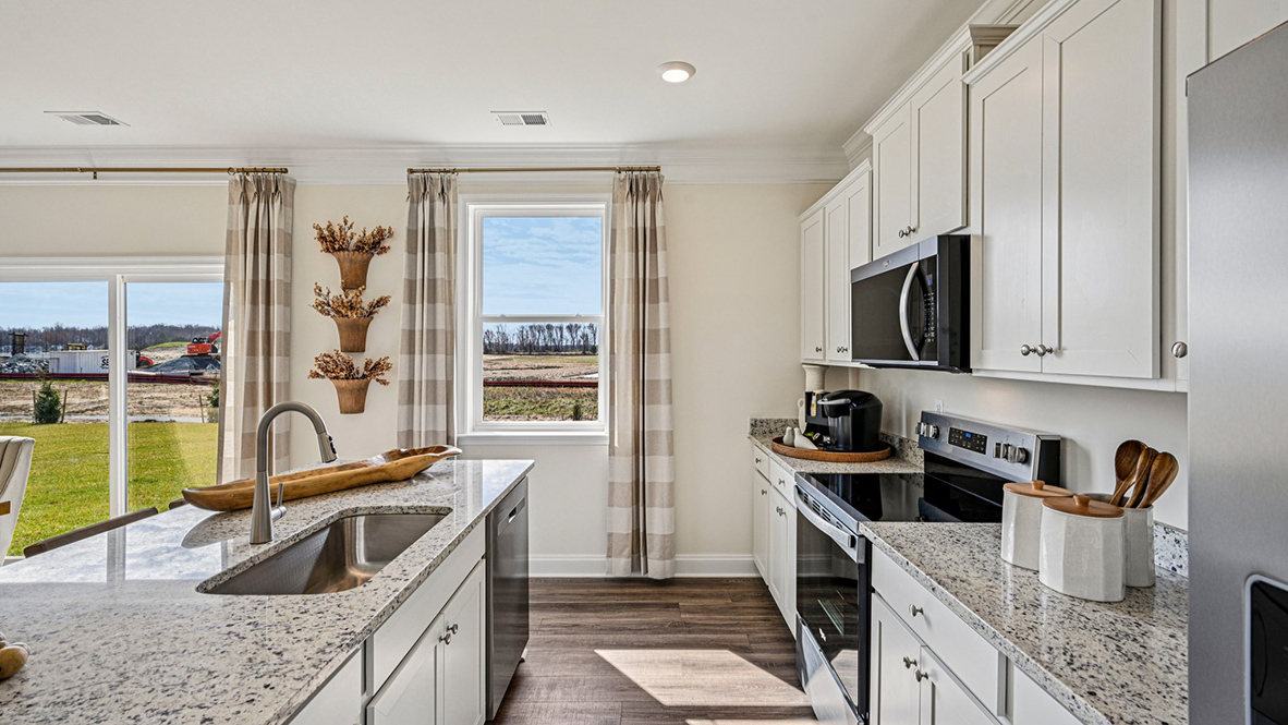 The well-designed gourmet kitchen features stainless steel appliances.