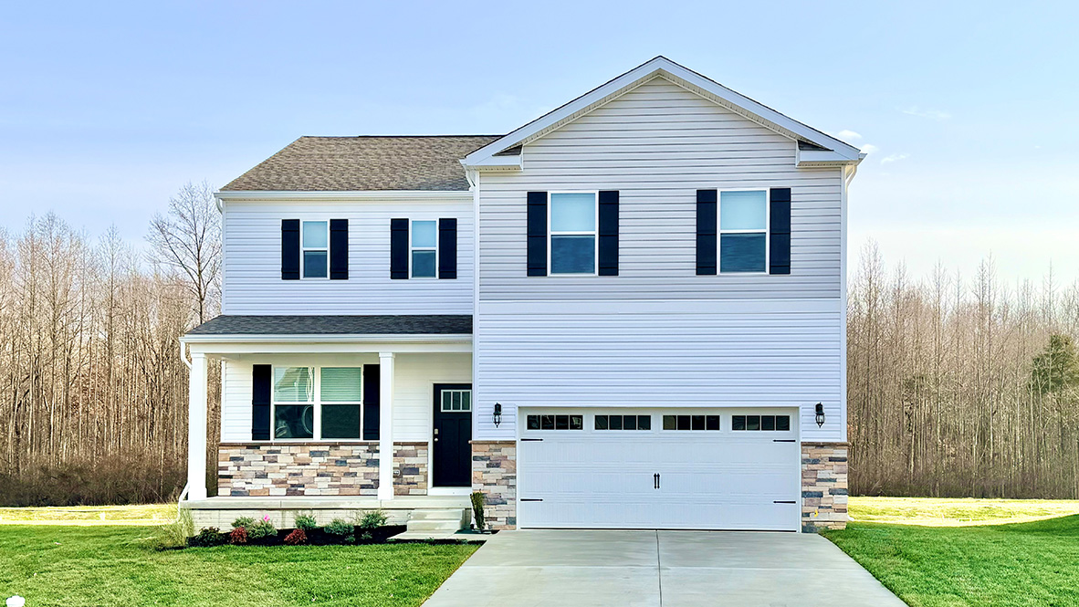 A two-story home with white siding and black shutters.