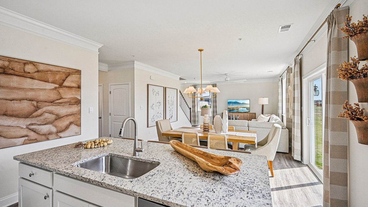The well-designed gourmet kitchen features beautiful quartz countertops.