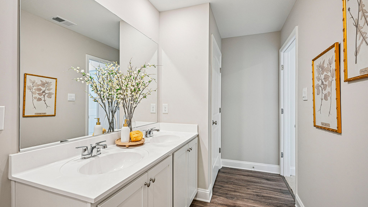 A spacious hall bathroom with double vanity completes the upstairs.