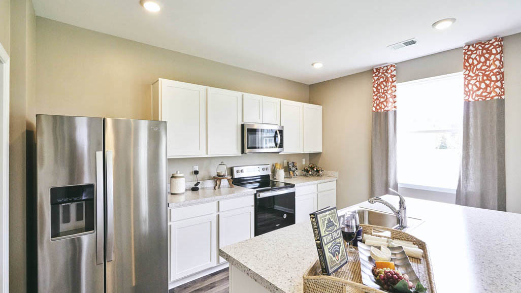 The well-designed kitchen features beautiful quartz countertops.