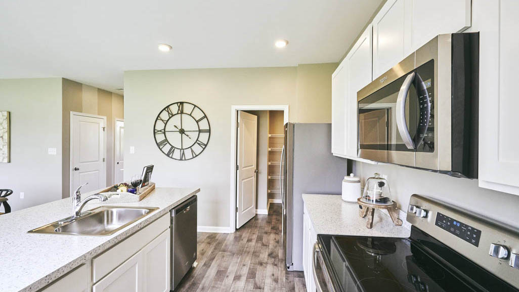 The well-designed kitchen features modern cabinetry.